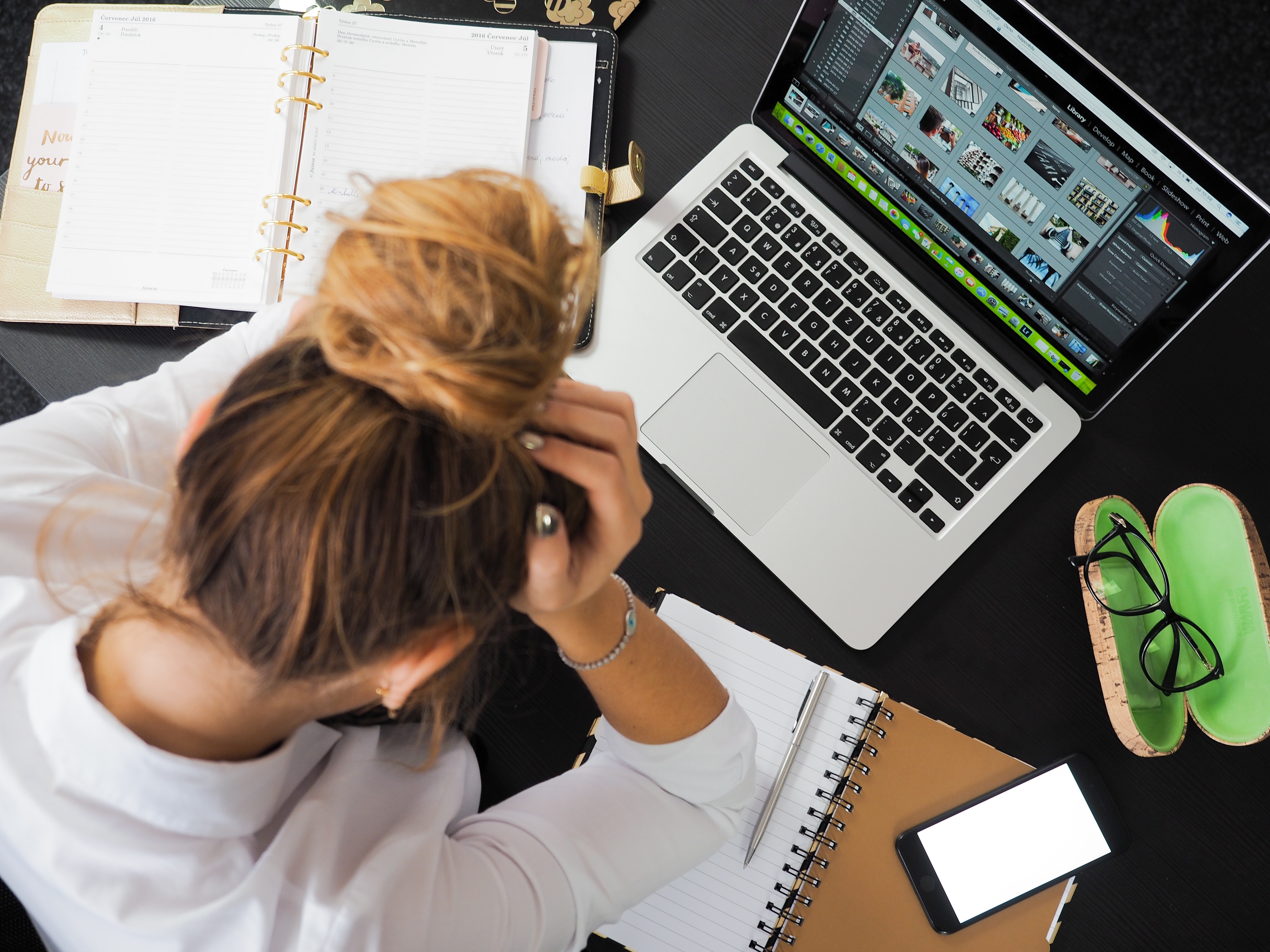 Photo of a frustrated woman using a laptop.