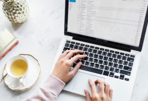 Photo of a woman checking her email on a laptop.