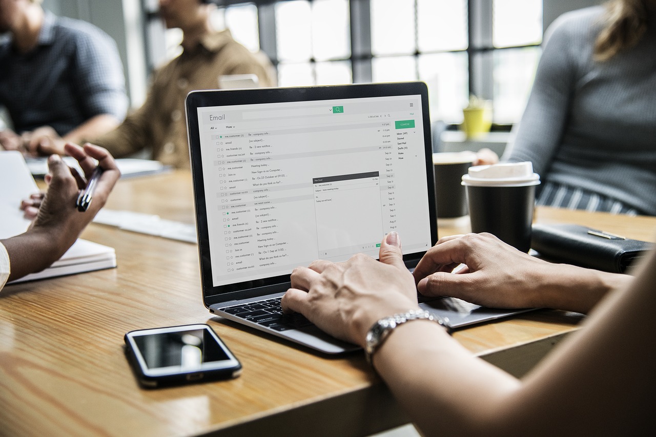 Photo of a person browsing her email inbox on a laptop.