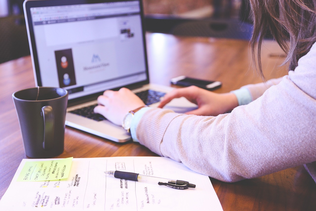 Woman working on a freelance writing assignment on her laptop.