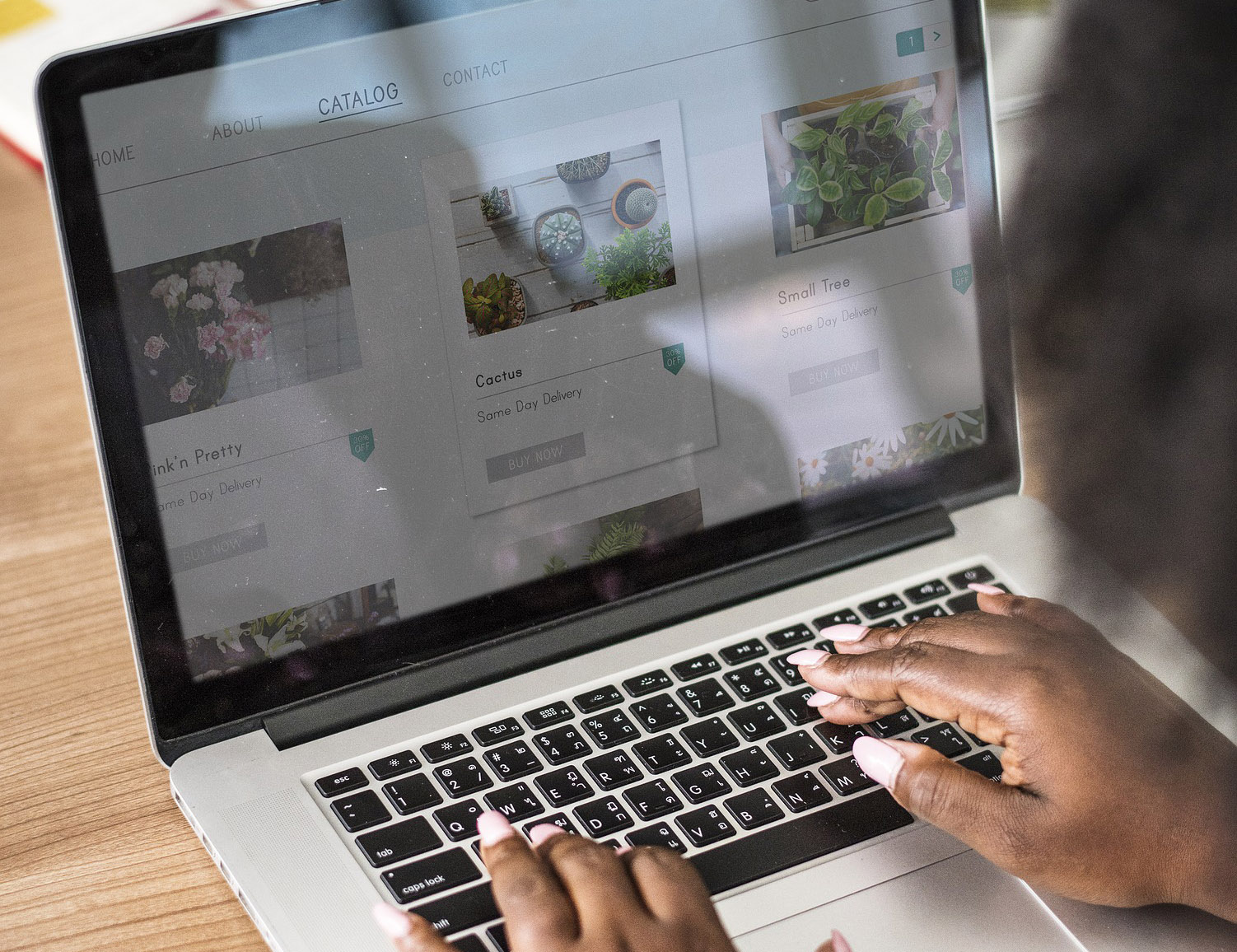 Photo of a woman writing on a laptop computer.