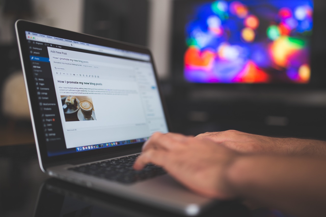 Photo of a person working on a blog post on a laptop computer.