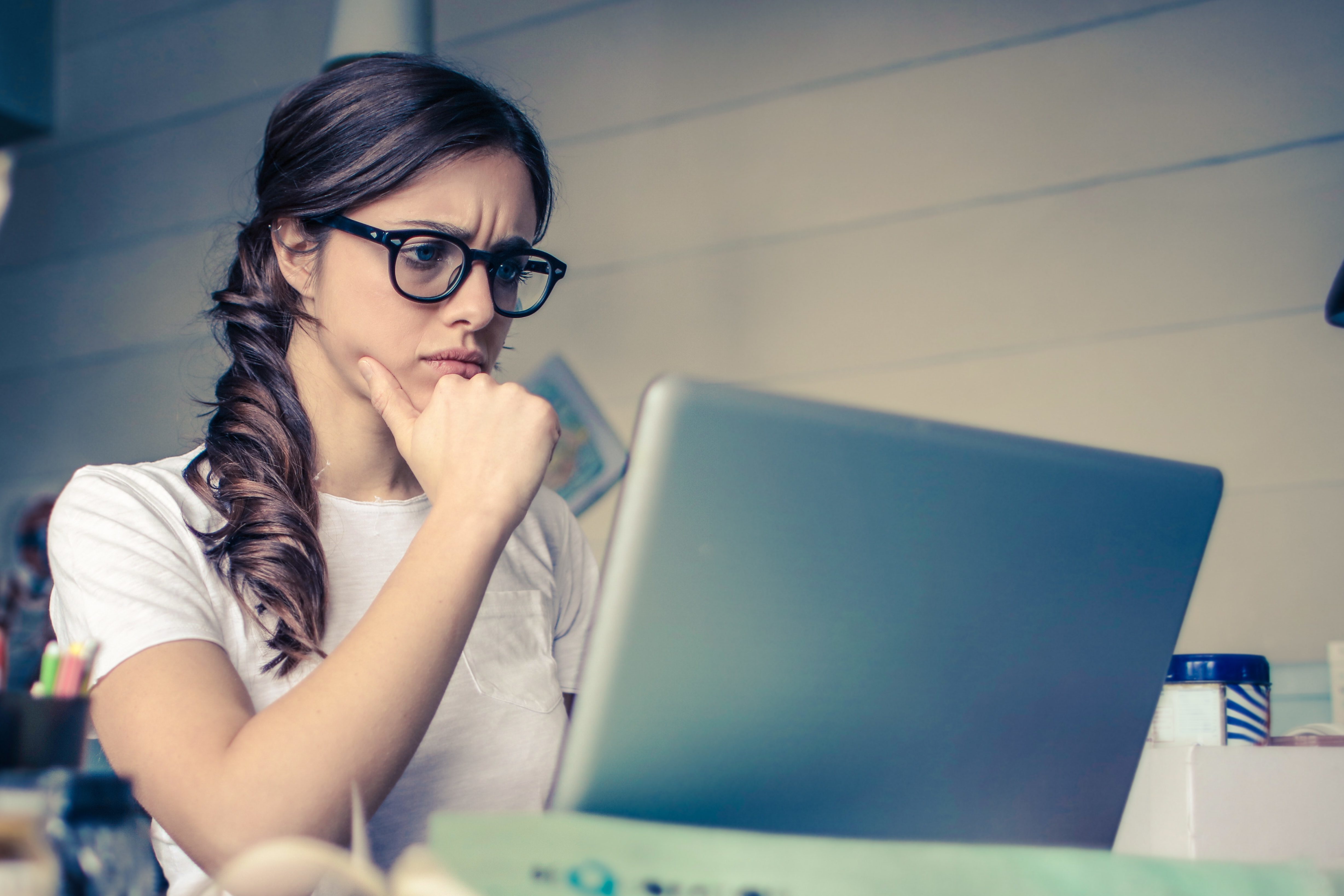 Photo of a woman concentrating on work with her laptop computer.