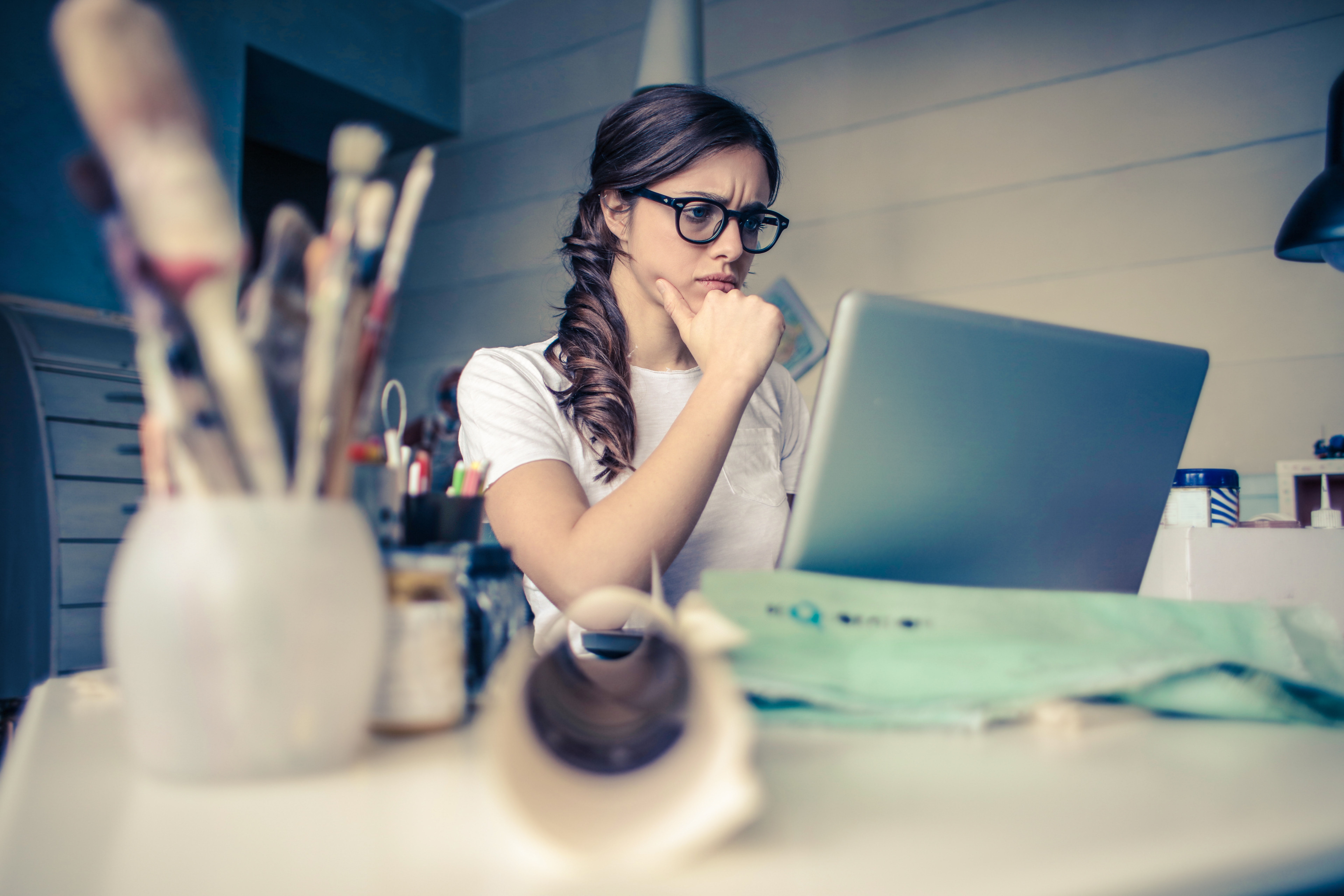 Photo of a woman concentrating on work with her laptop computer.
