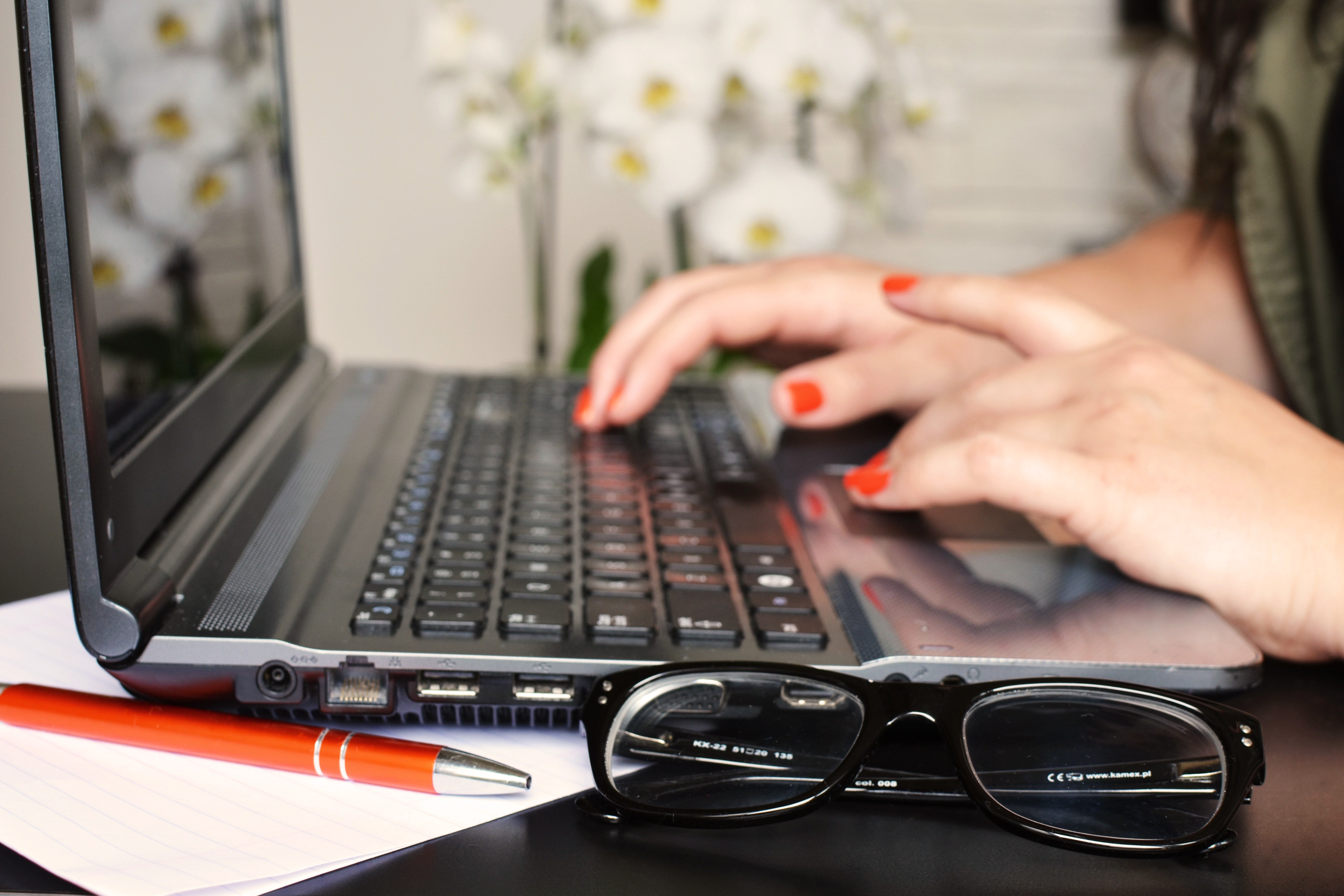 Freelance writer typing on her laptop.
