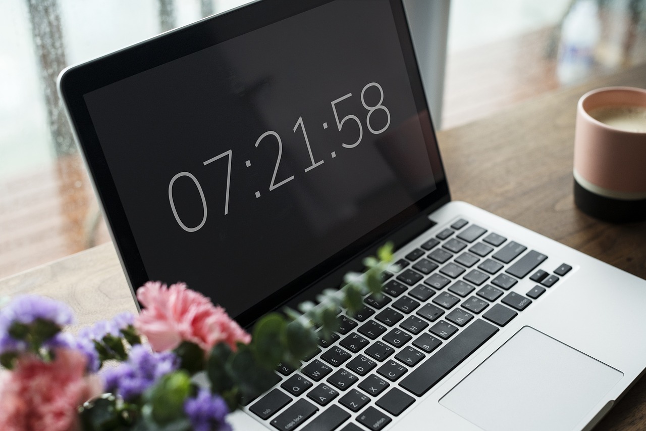 Photo of a laptop computer displaying a clock.