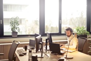 Photo of a man on a video call in a modern office.