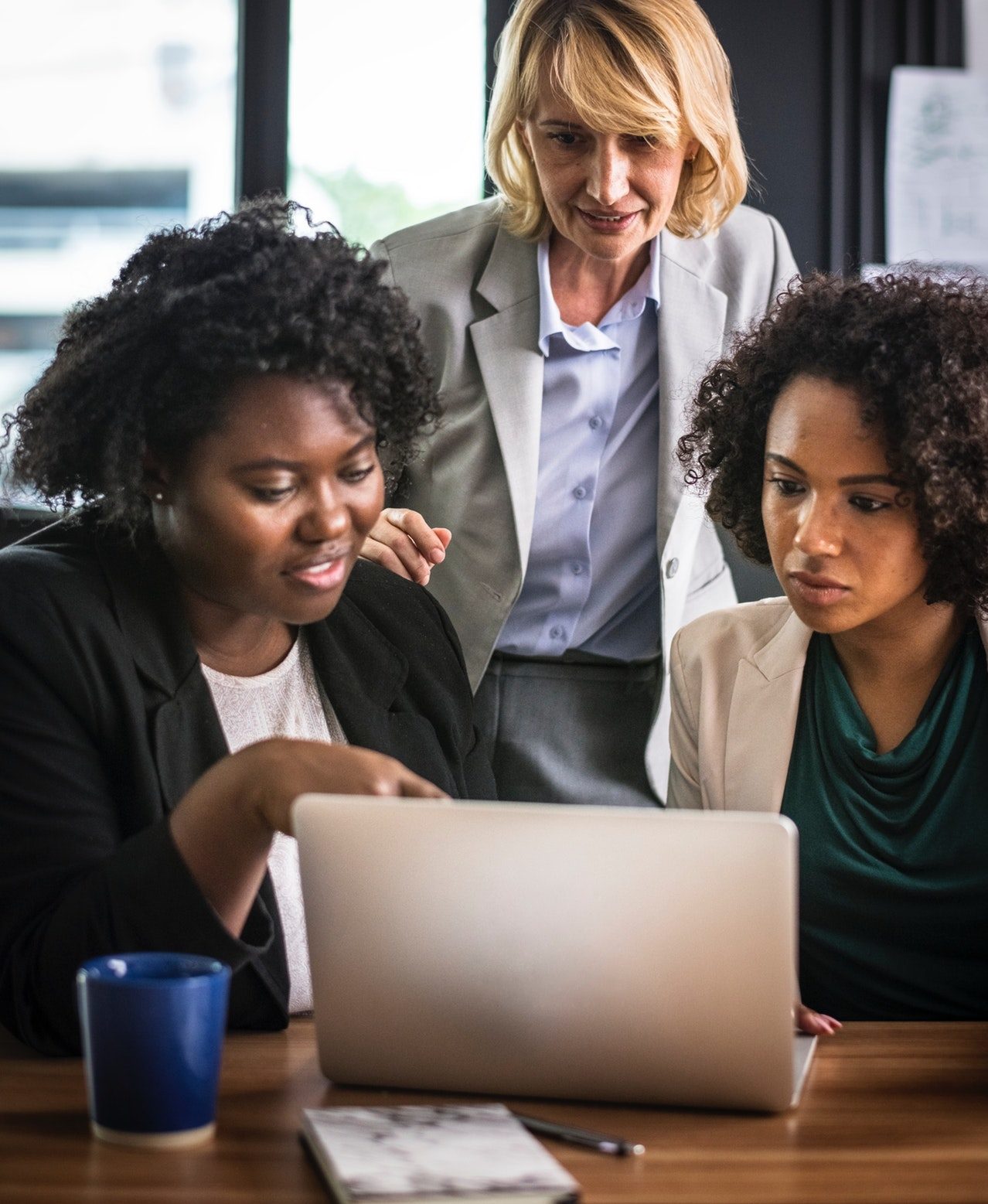 Three business women communicating with a freelance writer